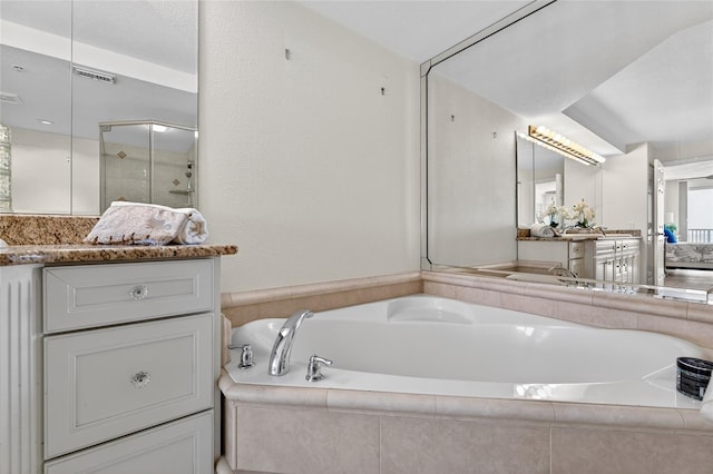 4555 S Atlantic Ave Unit 4603, Ponce Inlet, FL 32127 - full bath featuring a garden tub, vanity, and a stall shower