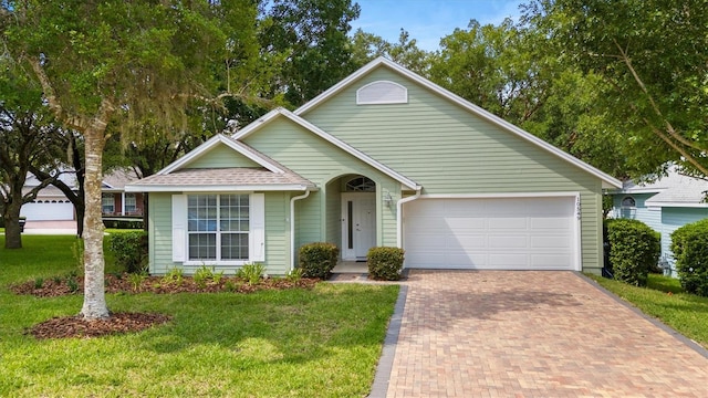 10549 NW 32nd Rd, Gainesville, FL 32606 - ranch-style home with decorative driveway, a garage, and a front yard