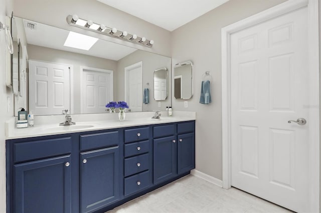 10549 NW 32nd Rd, Gainesville, FL 32606 - bathroom featuring double vanity, a skylight, and tile patterned flooring