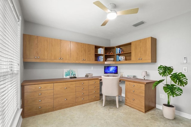 10549 NW 32nd Rd, Gainesville, FL 32606 - office space featuring built in desk, a ceiling fan, and light floors