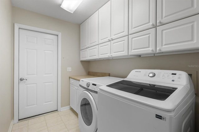 10549 NW 32nd Rd, Gainesville, FL 32606 - laundry area featuring cabinet space, independent washer and dryer, and light tile patterned floors