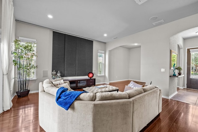 2750 NW 143rd Way, Newberry, FL 32669 - living area with arched walkways, dark wood finished floors, healthy amount of natural light, and recessed lighting