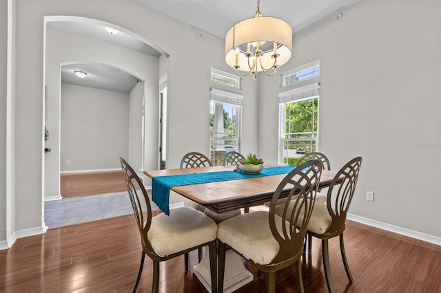 2750 NW 143rd Way, Newberry, FL 32669 - dining space with arched walkways, wood finished floors, and a chandelier