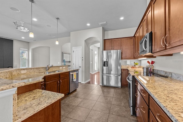 2750 NW 143rd Way, Newberry, FL 32669 - kitchen featuring stainless steel appliances, arched walkways, light stone countertops, pendant lighting, and recessed lighting