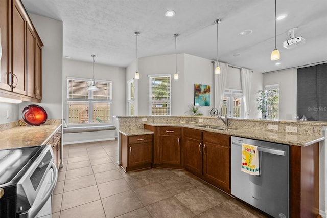 2750 NW 143rd Way, Newberry, FL 32669 - kitchen featuring appliances with stainless steel finishes, hanging light fixtures, light stone counters, tile patterned floors, and recessed lighting