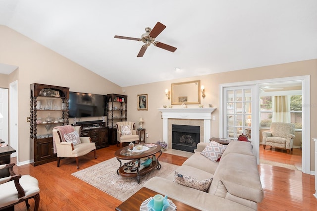 4705 SW 80th Ter, Gainesville, FL 32608 - living area featuring ceiling fan, light wood-style floors, lofted ceiling, and a fireplace with flush hearth