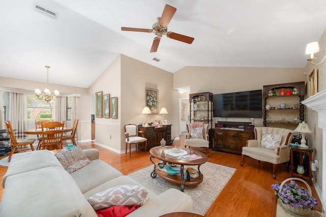 4705 SW 80th Ter, Gainesville, FL 32608 - living area featuring lofted ceiling, light wood-style flooring, a chandelier, and ceiling fan