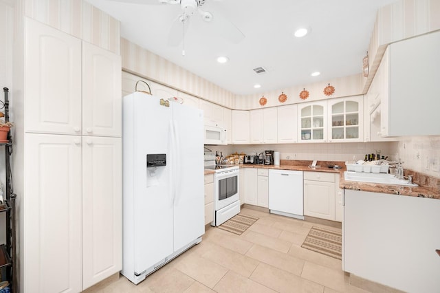 4705 SW 80th Ter, Gainesville, FL 32608 - kitchen featuring white appliances, glass insert cabinets, a ceiling fan, white cabinetry, and light tile patterned floors