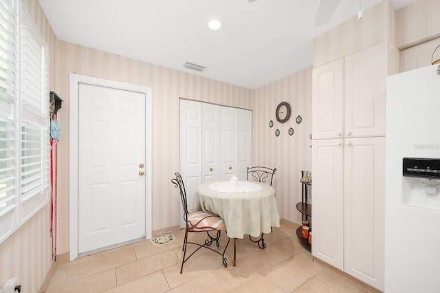 4705 SW 80th Ter, Gainesville, FL 32608 - dining room with wallpapered walls, light tile patterned flooring, and ceiling fan