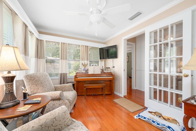 4705 SW 80th Ter, Gainesville, FL 32608 - living room featuring ornamental molding, wood finished floors, and a ceiling fan