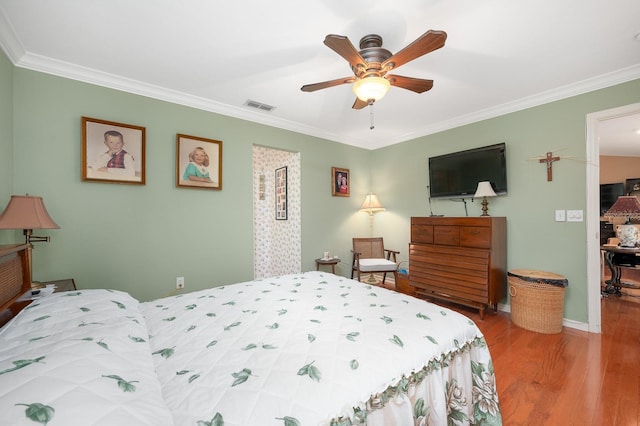 4705 SW 80th Ter, Gainesville, FL 32608 - bedroom featuring wood finished floors, ornamental molding, and ceiling fan