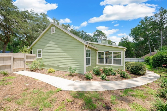 4705 SW 80th Ter, Gainesville, FL 32608 - view of home's exterior with a gate and a chimney