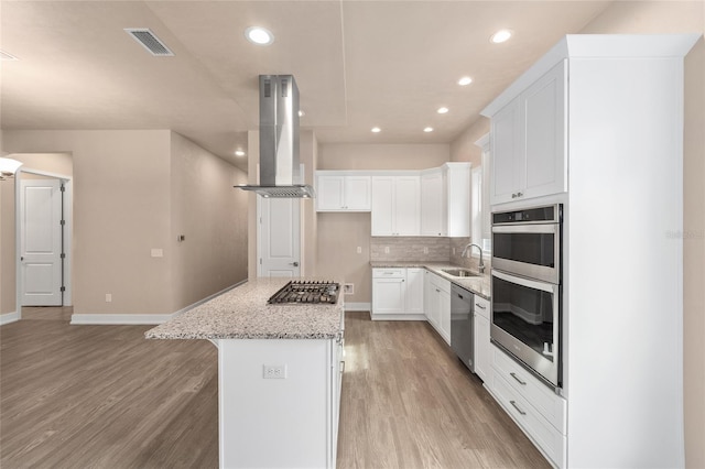 1080 NW 132nd Blvd, Newberry, FL 32669 - kitchen with island exhaust hood, stainless steel appliances, light wood-style floors, a kitchen island, and recessed lighting
