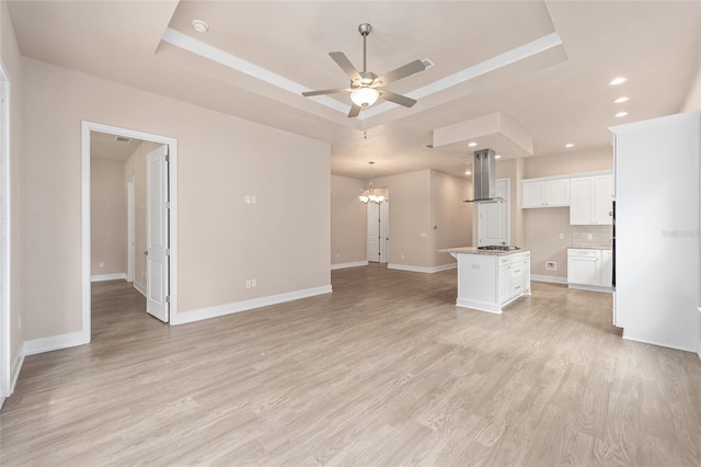 1080 NW 132nd Blvd, Newberry, FL 32669 - unfurnished living room featuring a raised ceiling, a chandelier, a ceiling fan, light wood-style floors, and recessed lighting