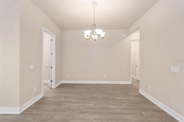1080 NW 132nd Blvd, Newberry, FL 32669 - unfurnished room featuring a chandelier and wood finished floors