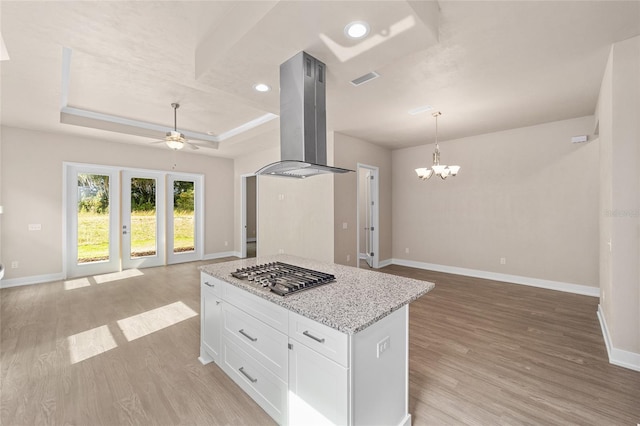 1080 NW 132nd Blvd, Newberry, FL 32669 - kitchen with stainless steel gas cooktop, open floor plan, island range hood, a ceiling fan, and a chandelier