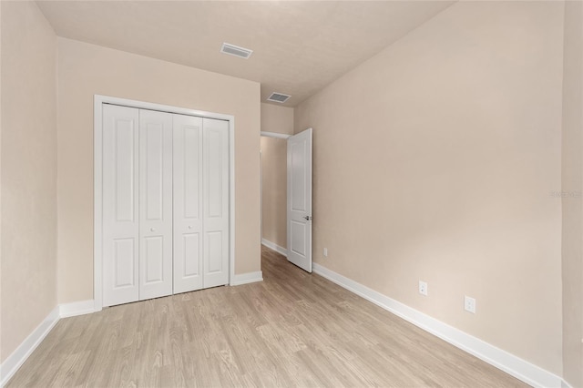 1080 NW 132nd Blvd, Newberry, FL 32669 - unfurnished bedroom with light wood-type flooring and a closet