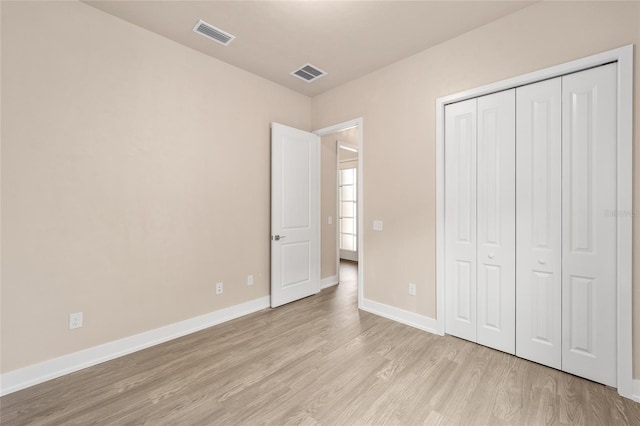 1080 NW 132nd Blvd, Newberry, FL 32669 - unfurnished bedroom with light wood-style flooring and a closet