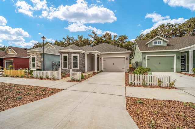 1080 NW 132nd Blvd, Newberry, FL 32669 - view of front of home featuring concrete driveway, an attached garage, stone siding, and roof with shingles