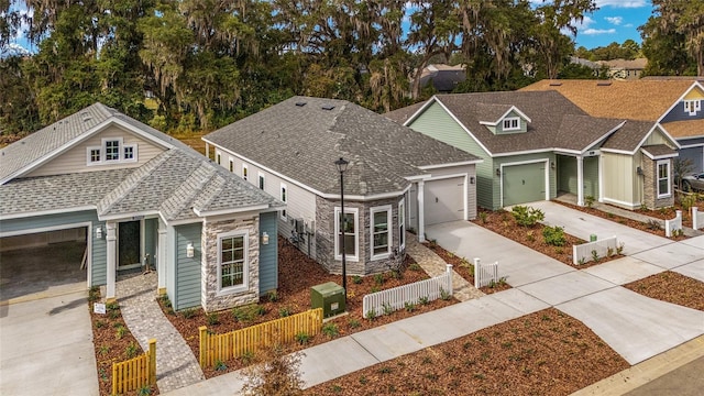 1080 NW 132nd Blvd, Newberry, FL 32669 - craftsman inspired home featuring a fenced front yard, concrete driveway, stone siding, and a garage