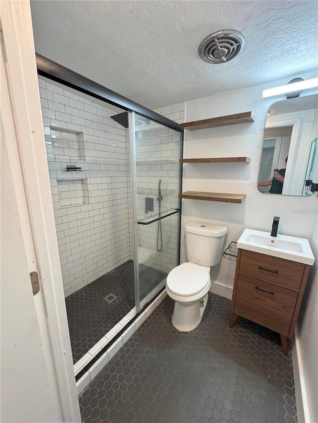 1215 NE 21st Ave, Gainesville, FL 32609 - full bath featuring vanity, a stall shower, a textured ceiling, and tile patterned floors