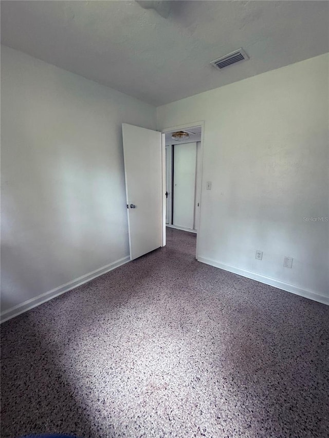 1215 NE 21st Ave, Gainesville, FL 32609 - unfurnished room with speckled floor and baseboards