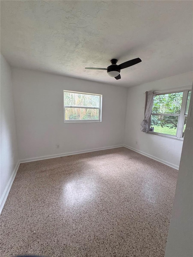 1215 NE 21st Ave, Gainesville, FL 32609 - spare room with healthy amount of natural light, ceiling fan, and a textured ceiling