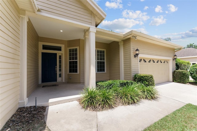 8650 SW 26th Ln, Gainesville, FL 32608 - entrance to property featuring an attached garage and concrete driveway