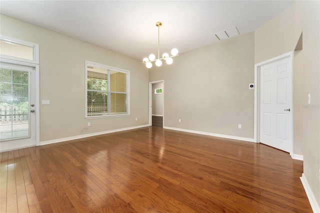 8650 SW 26th Ln, Gainesville, FL 32608 - empty room featuring a chandelier and hardwood / wood-style floors