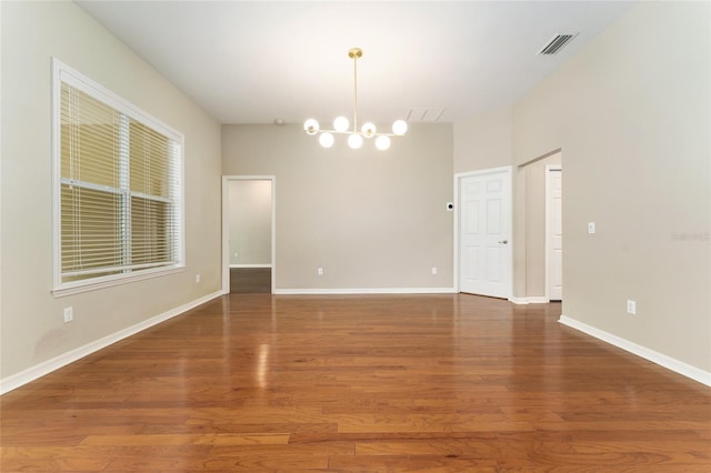 8650 SW 26th Ln, Gainesville, FL 32608 - unfurnished room with a chandelier and wood finished floors
