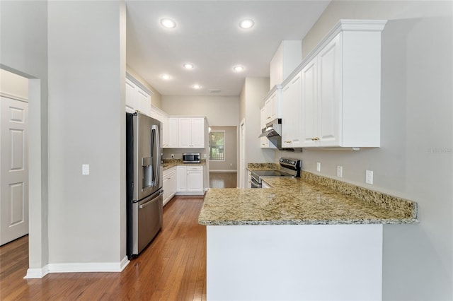 8650 SW 26th Ln, Gainesville, FL 32608 - kitchen with appliances with stainless steel finishes, a peninsula, light wood-style flooring, white cabinetry, and recessed lighting