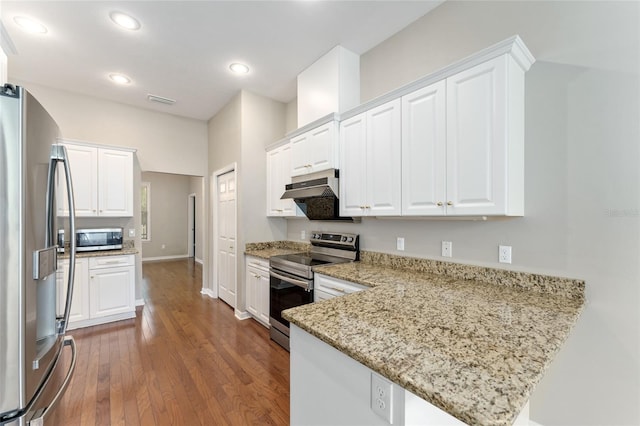 8650 SW 26th Ln, Gainesville, FL 32608 - kitchen with appliances with stainless steel finishes, exhaust hood, white cabinets, and recessed lighting