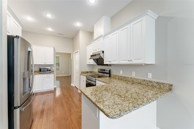 8650 SW 26th Ln, Gainesville, FL 32608 - kitchen with stainless steel appliances, white cabinets, and recessed lighting