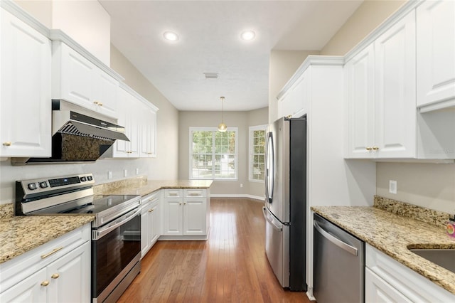 8650 SW 26th Ln, Gainesville, FL 32608 - kitchen with appliances with stainless steel finishes, white cabinetry, light wood finished floors, recessed lighting, and a peninsula