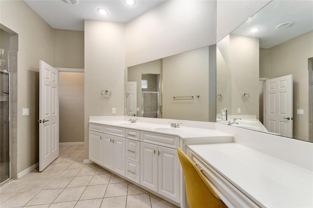 8650 SW 26th Ln, Gainesville, FL 32608 - bathroom with double vanity, tile patterned floors, a stall shower, and recessed lighting