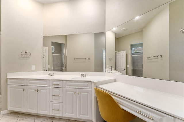 8650 SW 26th Ln, Gainesville, FL 32608 - full bathroom with double vanity, a shower with door, and tile patterned flooring