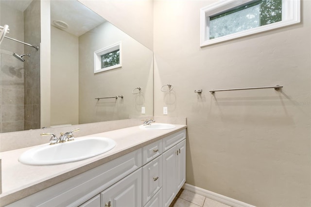 8650 SW 26th Ln, Gainesville, FL 32608 - bathroom with plenty of natural light, double vanity, tile patterned floors, and a tile shower