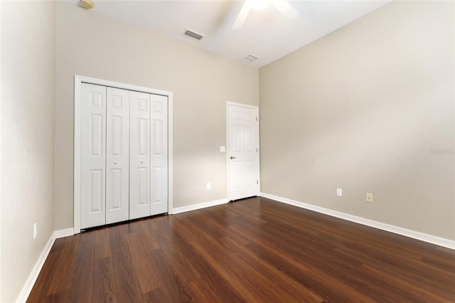 8650 SW 26th Ln, Gainesville, FL 32608 - unfurnished bedroom featuring dark wood-style flooring, a closet, and a ceiling fan