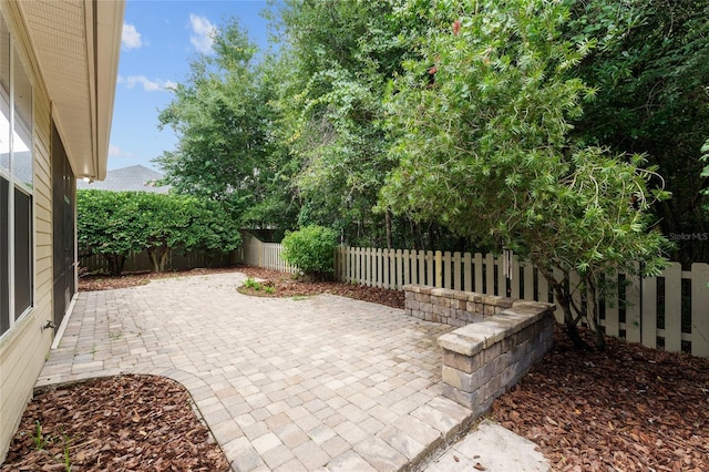 8650 SW 26th Ln, Gainesville, FL 32608 - fenced backyard with a patio area