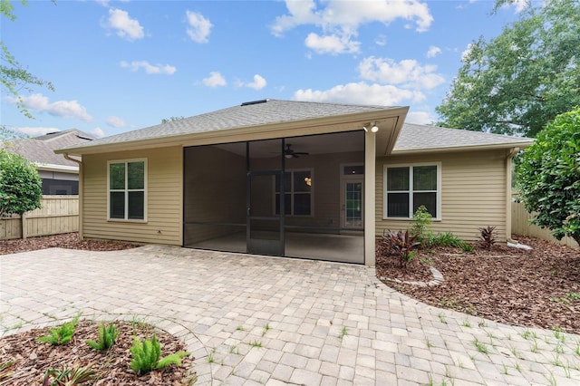 8650 SW 26th Ln, Gainesville, FL 32608 - back of house with a sunroom, ceiling fan, a patio, and roof with shingles