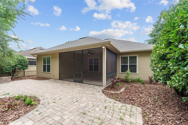 8650 SW 26th Ln, Gainesville, FL 32608 - back of property with a sunroom, a patio area, a ceiling fan, and a shingled roof