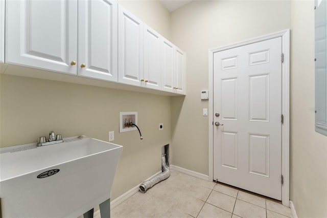 8650 SW 26th Ln, Gainesville, FL 32608 - laundry area with hookup for an electric dryer, cabinet space, hookup for a washing machine, and light tile patterned floors