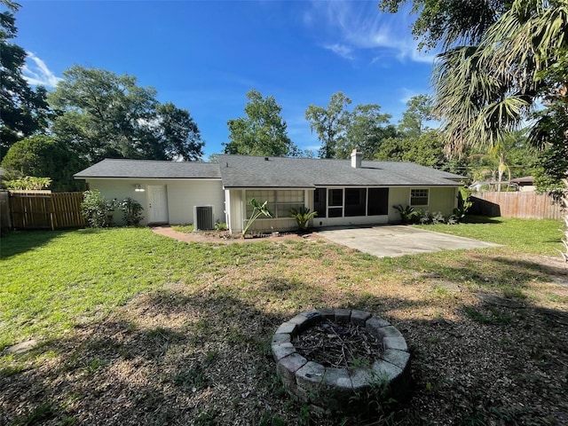 4121 NW 15th Pl, Gainesville, FL 32605 - back of house with a patio, a sunroom, and an outdoor fire pit