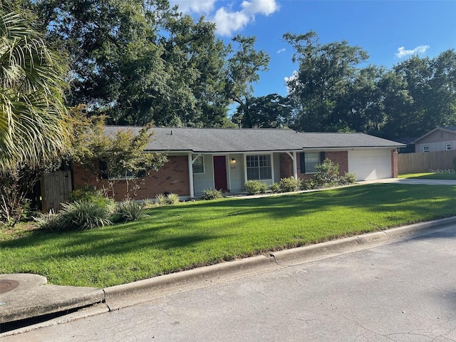 4121 NW 15th Pl, Gainesville, FL 32605 - single story home featuring an attached garage, brick siding, and driveway