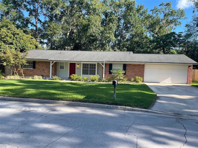 4121 NW 15th Pl, Gainesville, FL 32605 - single story home featuring concrete driveway, an attached garage, a front lawn, and brick siding