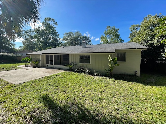 4121 NW 15th Pl, Gainesville, FL 32605 - rear view of house with a lawn, a patio area, and a chimney
