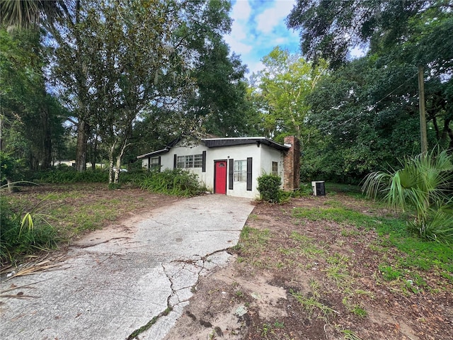 1402 SE 27th St, Gainesville, FL 32641 - bungalow-style house with stucco siding, concrete driveway, and a chimney