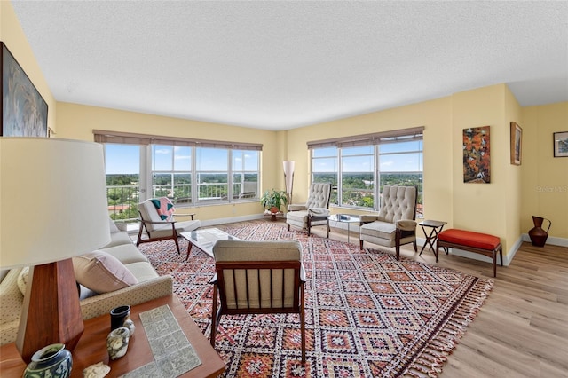 10777 W Sample Rd Unit 1212, Coral Springs, FL 33065 - living area featuring wood finished floors and a textured ceiling