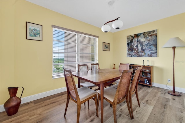 10777 W Sample Rd Unit 1212, Coral Springs, FL 33065 - dining space with light wood-style flooring and baseboards