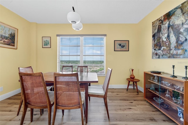 10777 W Sample Rd Unit 1212, Coral Springs, FL 33065 - dining space featuring light wood-type flooring and baseboards